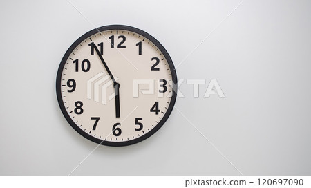 Classic Black-Edged Clock on White Background at 17.55/05.55 - Perfect for Time Management and Text Space 120697090