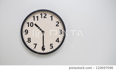 Classic Black-Edged Clock on White Background at 22.30/10.30 - Perfect for Time Management and Text Space Classic Black-Edged Clock on White Background at 22.30/10.30 - Perfect for Time Management and Text Space 120697096