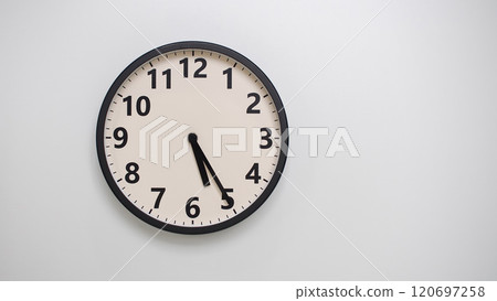 Classic Black-Edged Clock on White Background at 17.25/05.25 - Perfect for Time Management and Text Space 120697258