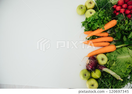 carrots, vegetables, apples and radishes for cooking on a white background carrots, vegetables, apples and radishes for cooking on a white background 120697345