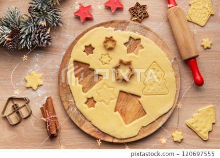Preparing christmas cookies with dough, cutters, and festive decorations 120697555