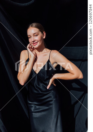 Beautiful fashion woman in black evening silk dress Beautiful fashion woman in black evening silk dress 120697844