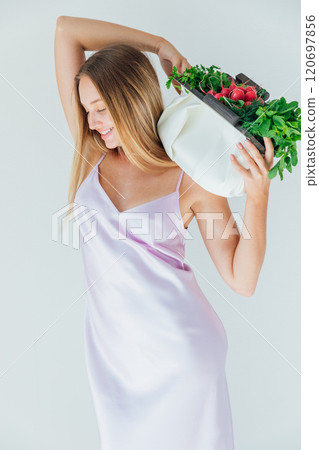 Beautiful woman with a bag of green vegetables for a diet 120697856