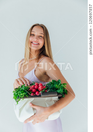 Beautiful woman with a bag of green vegetables for a diet Beautiful woman with a bag of green vegetables for a diet 120697857
