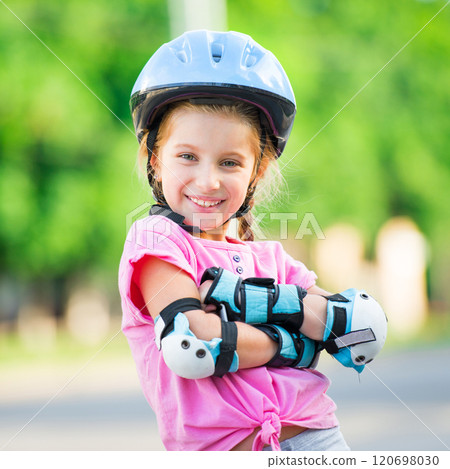 Little girl on roller skates at park 120698030