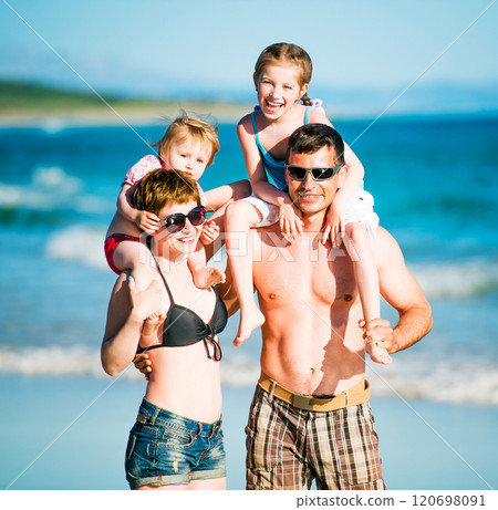 Family having fun at the beach 120698091