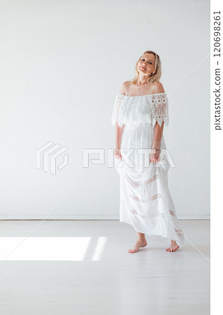 Beautiful blonde woman in summer white wedding dress Beautiful blonde woman in summer white wedding dress 120698261