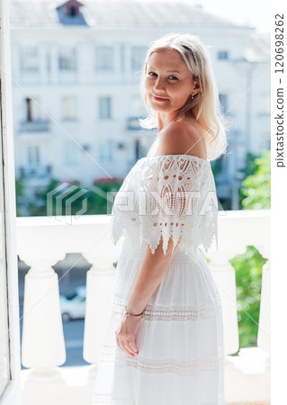 Beautiful woman in summer dress smiling Beautiful woman in summer dress smiling 120698262