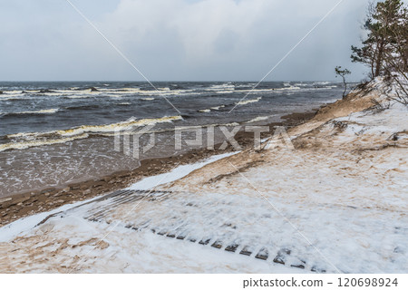 Footpath between winter Baltic Sea s dunes in Saulkrasti in Latvia Footpath between winter Baltic Sea s dunes in Saulkrasti in Latvia 120698924