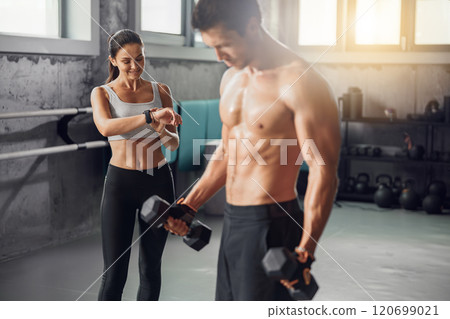 Participating in a Dedicated and Focused Workout Session at a StateoftheArt Modern Gym Facility 120699021
