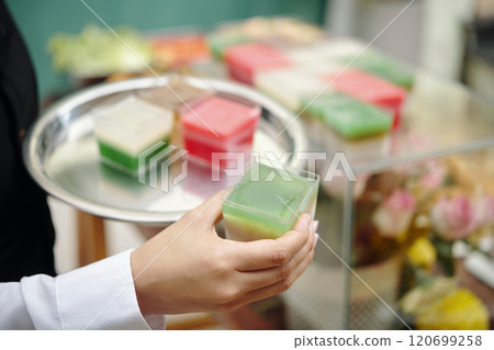 Hand Holding Tray with Colorful Cubes of Soap or Jelly Hand Holding Tray with Colorful Cubes of Soap or Jelly 120699258