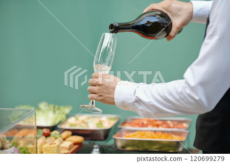 Pouring Wine During a Catering Event for Guests 120699279