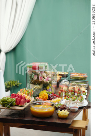 Displaying Assorted Fruits and Sweet Treats on Table Displaying Assorted Fruits and Sweet Treats on Table 120699288