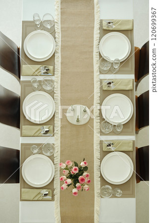 Elegant Dining Table Setting with Floral Centerpiece Elegant Dining Table Setting with Floral Centerpiece 120699367