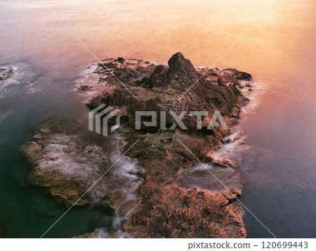 Coastal rocks dyed red by the setting sun, Sehira Nature Park, Kagoshima Prefecture 120699443