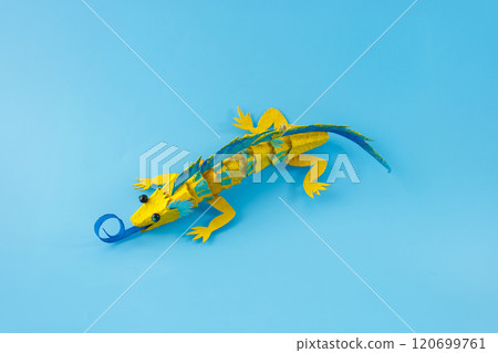 an upcycled egg box lizard. blue background , artistic creativity, unique and imaginative, 120699761