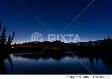 Pyramid Mountain silhouette reflected on Athabasca River at twilight time. Town Jasper at night. Alberta, Canada. 120700085