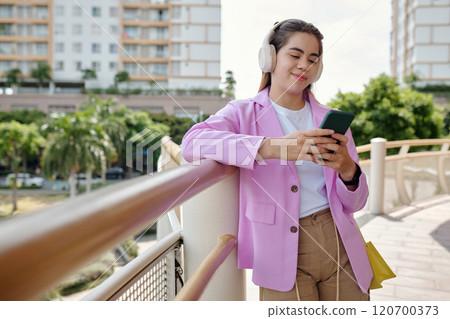 Listening Music While Walking on Bridge in Urban Area Listening Music While Walking on Bridge in Urban Area 120700373