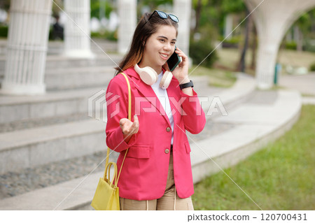 Talking on Phone While Wearing Bright Pink Blazer Talking on Phone While Wearing Bright Pink Blazer 120700431