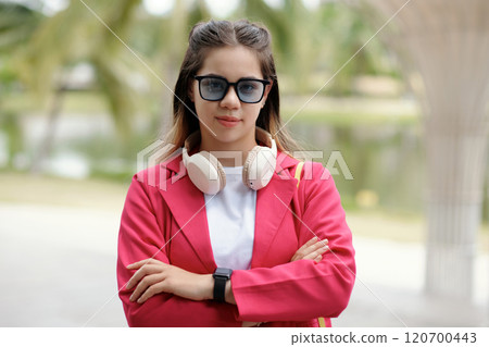 Wearing Headphones and Sunglasses in Outdoor Setting 120700443