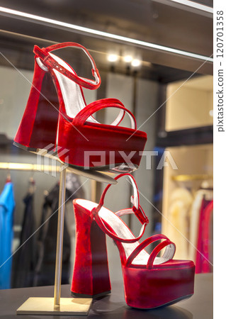 Red elegant platform and high heel sandals on shoe store showcase 120701358