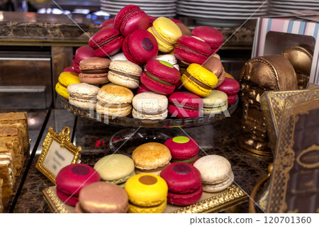 Large pile of macarons in glass vase in pastry vintage expensive cafe 120701360