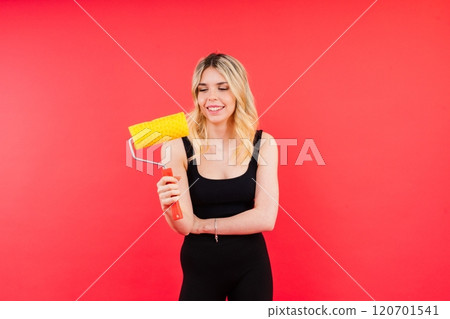 Excited female builder. Painter with painting brush tool or paint roller. Excited female builder. Painter with painting brush tool or paint roller. 120701541