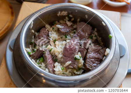 Rare beef rice in a steamed pot with butter. Korean food Rare beef rice in a steamed pot with butter. Korean food 120701644