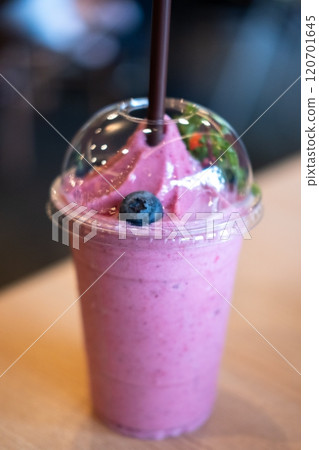 Mixed berry smoothie on the wooden table with blurred image bokeh of the restaurant Mixed berry smoothie on the wooden table with blurred image bokeh of the restaurant 120701645