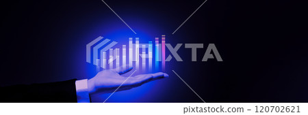 Holographic display of bar graphs emerging from hand, showcasing modern technology and dynamic business analytics. 120702621