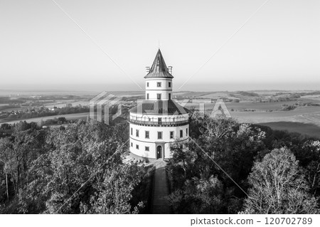 The elegant Baroque Humprecht chateau stands majestically against the backdrop of an autumn sunrise, overlooking the serene landscape of Bohemian Paradise near Sobotka. 120702789