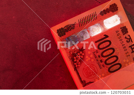 A stack of bills on a red background A stack of bills on a red background 120703031