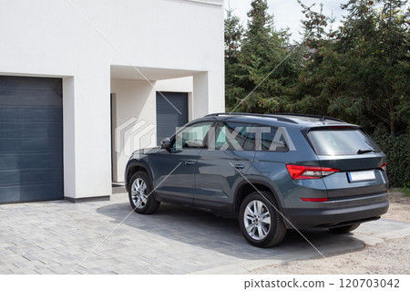Modern SUV Parked by Residential House 120703042
