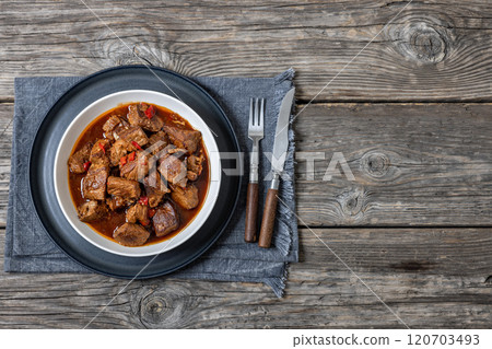 beef stew in a white bowl on rustic wooden table beef stew in a white bowl on rustic wooden table 120703493