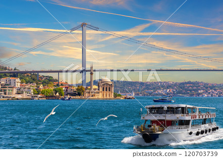 The cruise boat on the Bosphorus near the Grand Imperial Ortakoy Mosque, Istanbul, Turkey 120703739