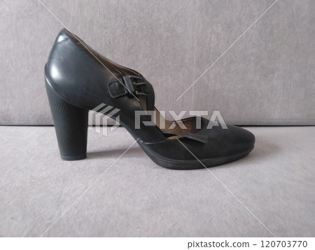 Elegant black leather high heel shoe on grey background, side view 120703770
