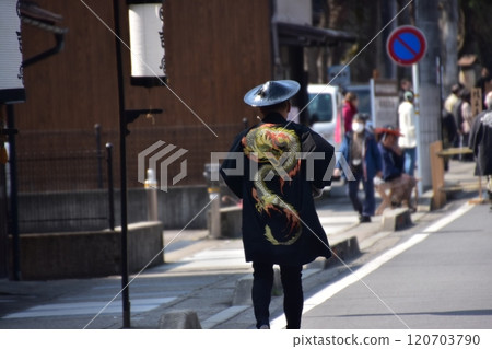 日本岐阜縣高山市，一名身著法衣、身穿 jingasa 的男子在後巷參加節慶。 120703790