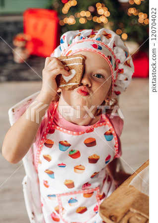 a girl child in the kitchen with a Christmas tree 120704022
