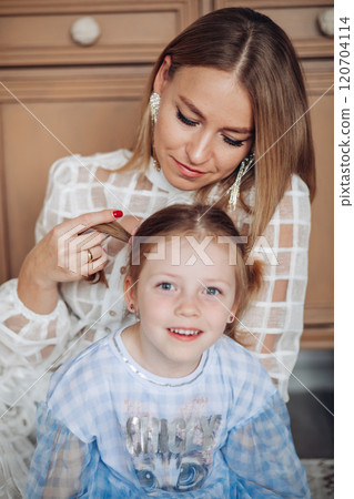 Smiling girl with mom near christmas tree at home 120704114