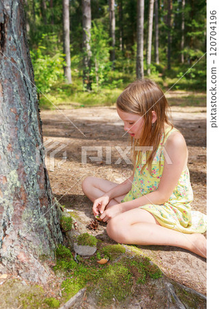 Child building a miniature forest setup at the base of a tree Child building a miniature forest setup at the base of a tree 120704196