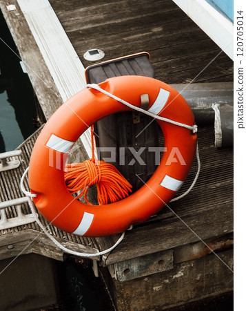 Lifebuoy in the marina. Life safety ring of a red buoy on a pole 120705014