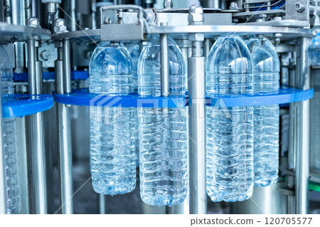 Drink water plant. Robotic of water bottles production line in factory. Process of filling water into plastic bottles to bring out to consumers. 120705577