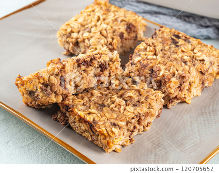 Baked oatmeal peanut butter banana cake bars with chocolate chips 120705652