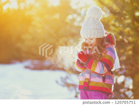 Winter happy smiling little girl child over sunny snowy background 120705751