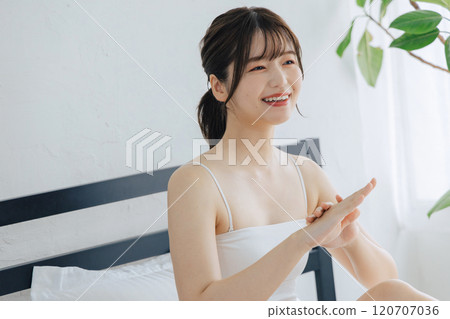 Women painting hand cream 120707036