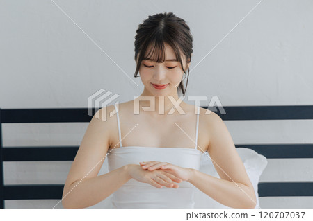 Women painting hand cream 120707037
