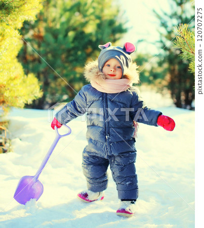 Winter little child playing with shovel toy in snow Winter little child playing with shovel toy in snow 120707275