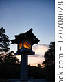 Shrine lanterns lit up in the sunset sky 120708028