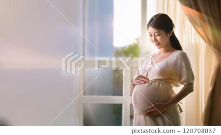 Pregnant woman looking outside 120708037