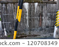 Yellow road sign and old wall 120708349